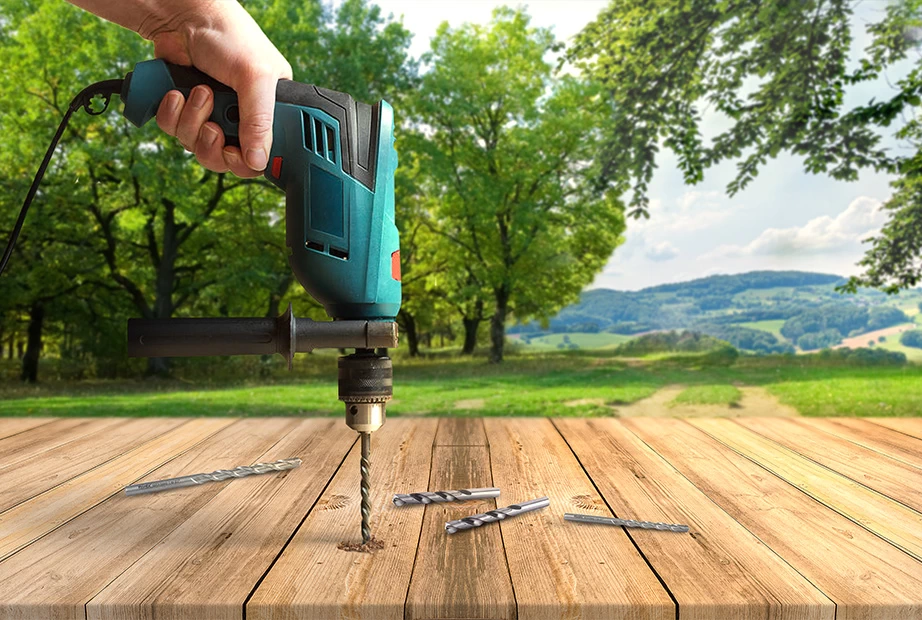 A Corded Drill Drilling Wood in a Jungle