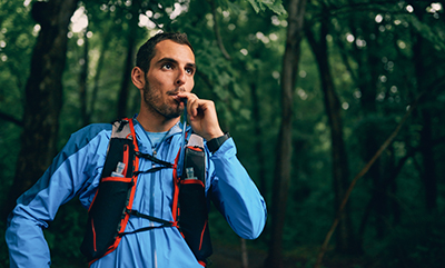 A hiker takes a drink from his hydration pack.